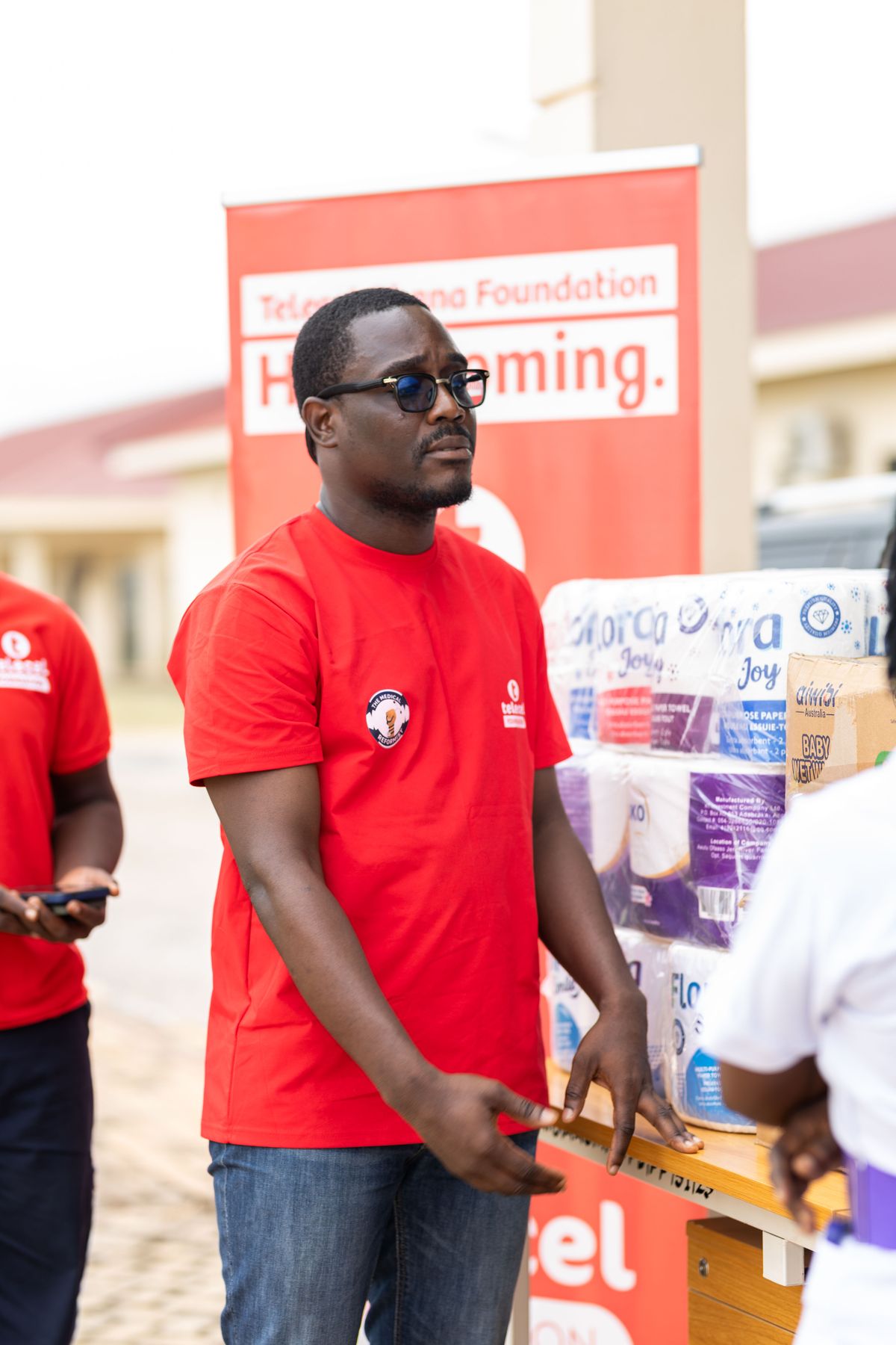 A community volunteer distributing supplies; no implication of wrongdoing